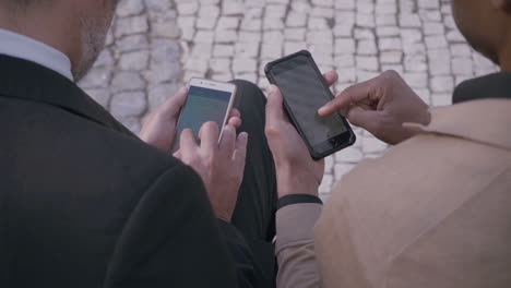 Multicultural-men-using-smartphones